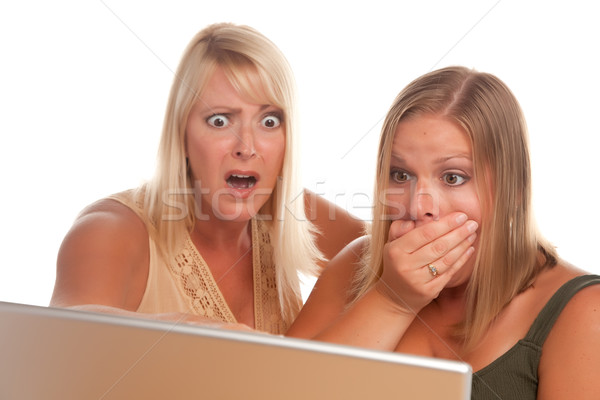 Kettő megrémült nők laptopot használ izolált fehér Stock fotó © feverpitch