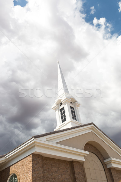 Church Steeple Tower Below Ominous Stormy Thunderstorm Clouds. Stock photo © feverpitch