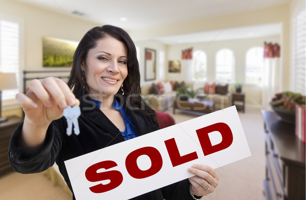 Hispanic Woman with Keys and Sold Sign in Living Room Stock photo © feverpitch