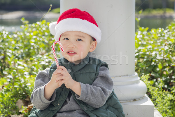 Cute Mixed Race Boy With Santa Hat and Candy Cane Stock photo © feverpitch