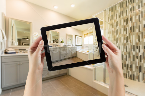 Master Bathroom Interior and Hands Holding Computer Tablet with  Stock photo © feverpitch