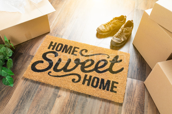 Home Sweet Home Welcome Mat, Moving Boxes, Shoes and Plant on Ha Stock photo © feverpitch