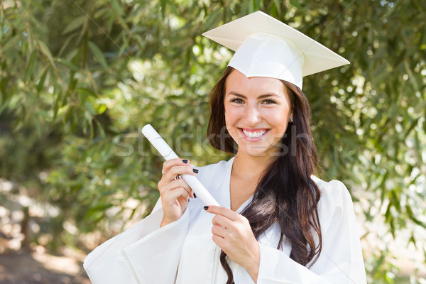 Attractive Mixed Race Girl Celebrating Graduation Outside In Cap Stock photo © feverpitch