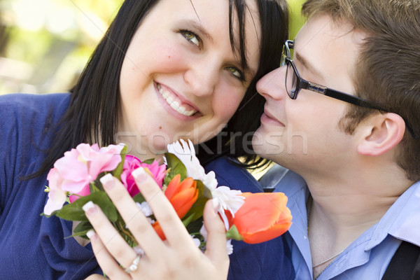 Attractive Young Man Gives Flowers to His Love Stock photo © feverpitch