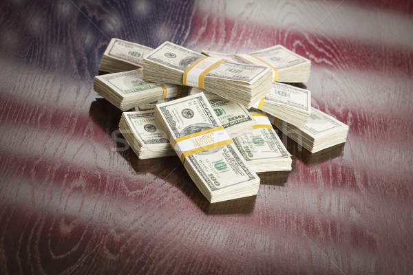 Thousands of Dollars with Reflection of American Flag on Table Stock photo © feverpitch