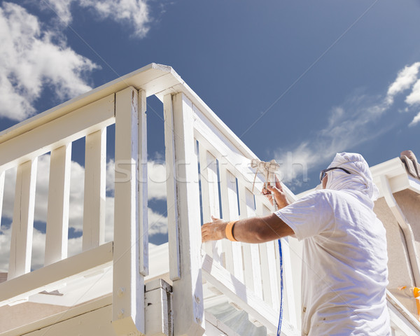 House Painter Spray Painting A Deck of A Home Stock photo © feverpitch