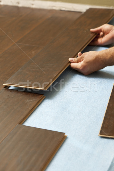 Man Installing New Laminate Wood Flooring Stock photo © feverpitch