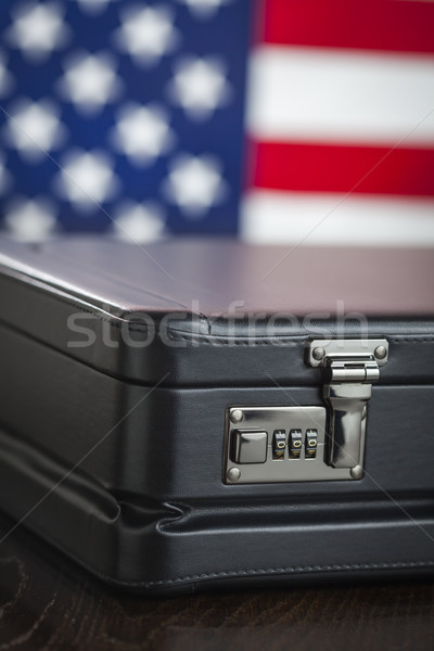 Leather Briefcase Resting on Table with American Flag Behind Stock photo © feverpitch