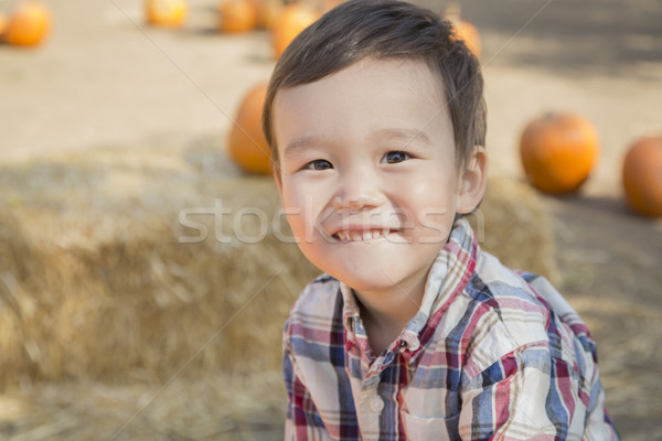 Stock photo: Mixed Race Young Boy Having Fun at the Pumpkin Patch