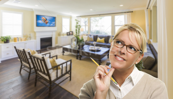 Stock photo: Daydreaming Woman with Pencil Inside Beautiful Living Room