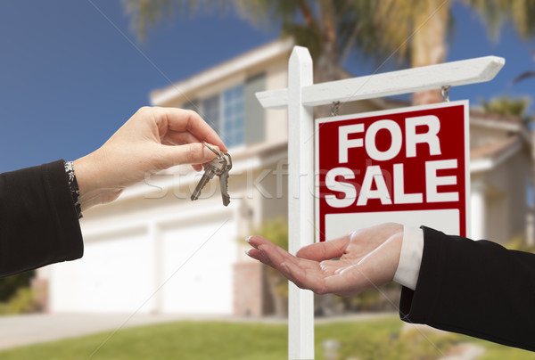 Agent Handing Over House Keys in Front of New Home Stock photo © feverpitch