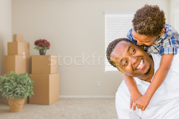 Mixed Race African American Father and Son In Room with Packed M Stock photo © feverpitch