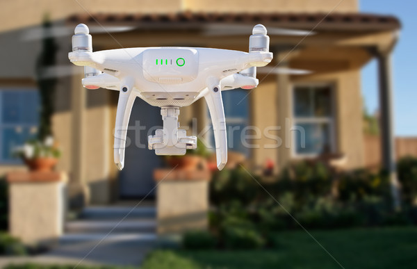 Back of Unmanned Aircraft System (UAV) Quadcopter Drone Flying I Stock photo © feverpitch