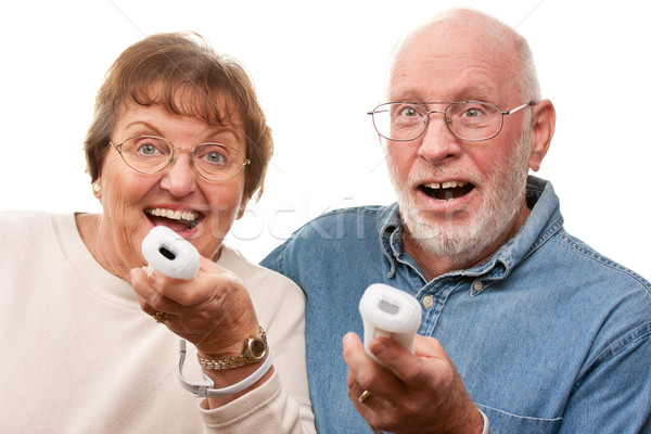 Happy Senior Couple Play Video Game with Remotes Stock photo © feverpitch