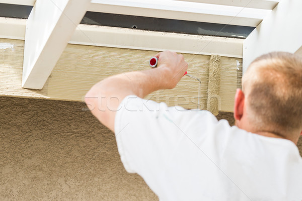 Professional Painter Using Small Roller to Paint House Fascia Stock photo © feverpitch