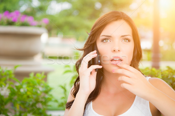 Shocked Young Adult Female Talking on Cell Phone Outdoors Stock photo © feverpitch