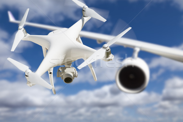 Unmanned Aircraft System (UAV) Quadcopter Drone In The Air Too C Stock photo © feverpitch