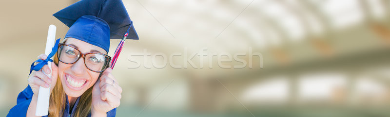 Goofy Graduating Young Girl In Cap and Gown Banner. Stock photo © feverpitch