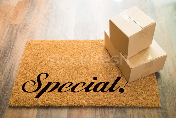 Special Welcome Mat On Wood Floor With Shipment of Boxes Stock photo © feverpitch