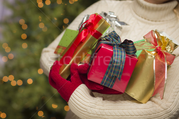Stock photo: Woman Wearing Seasonal Red Mittens Holding Christmas Gifts