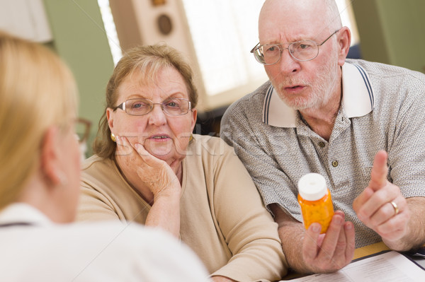 Doctor or Nurse Explaining Prescription Medicine to Senior Coupl Stock photo © feverpitch