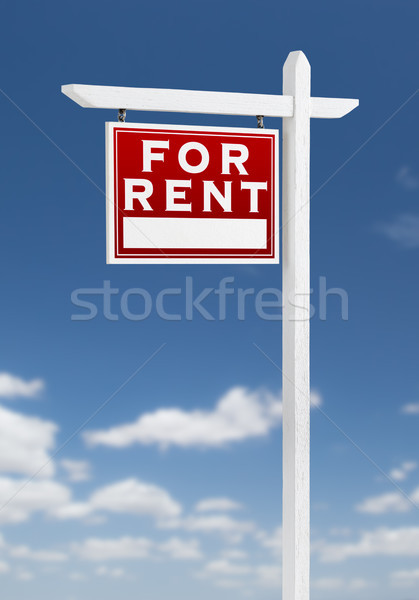 Left Facing For Rent Real Estate Sign on a Blue Sky with Clouds. Stock photo © feverpitch