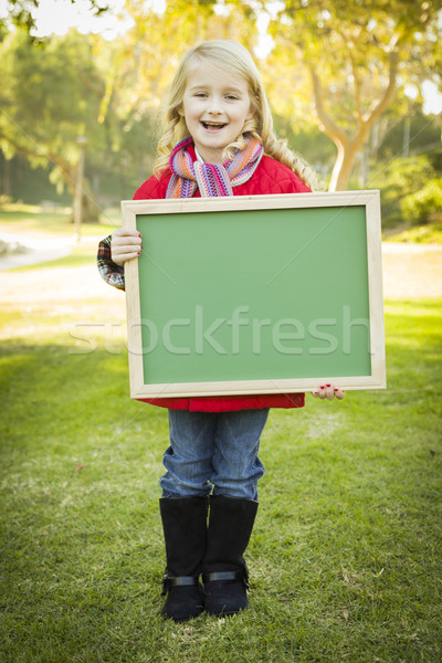 Cute Girl Holding a Green Chalkboard Wearing Winter Coat Outdoor Stock photo © feverpitch