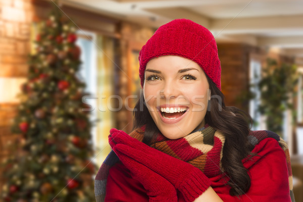 Stock photo: Mixed Race Woman Wearing Mittens and Hat In Christmas Setting