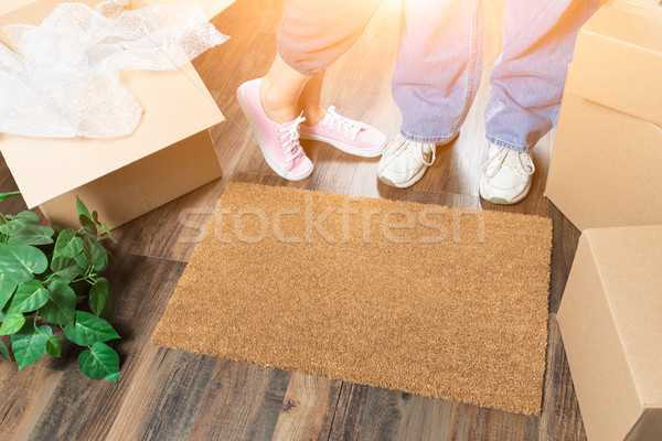 Man and Woman Standing Near Home Sweet Home Welcome Mat, Moving  Stock photo © feverpitch