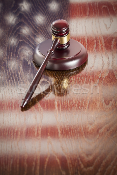 Wooden Gavel Resting on Flag Reflecting Table Stock photo © feverpitch