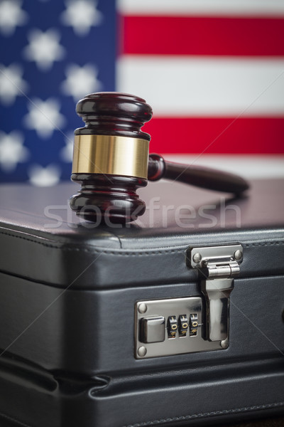 Briefcase and Gavel Resting on Table with American Flag Behind Stock photo © feverpitch