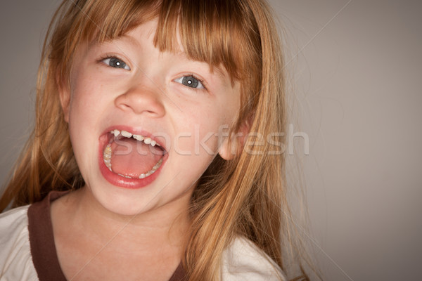 Fun Portrait of an Adorable Red Haired Girl on Grey Stock photo © feverpitch