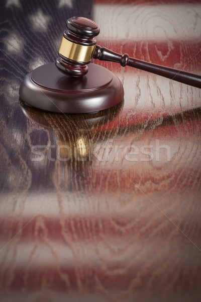 Wooden Gavel Resting on Flag Reflecting Table Stock photo © feverpitch