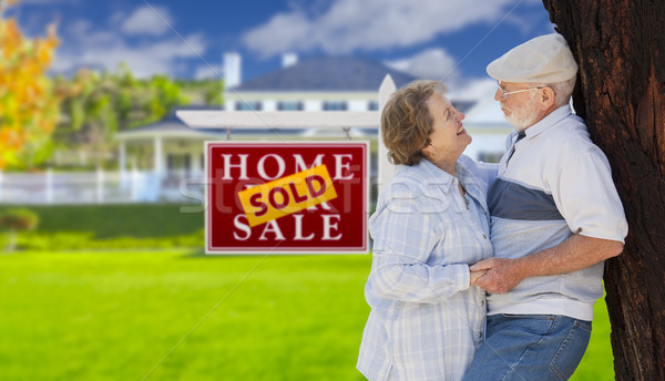 Sold Real Estate Sign with Senior Couple in Front of House Stock photo © feverpitch