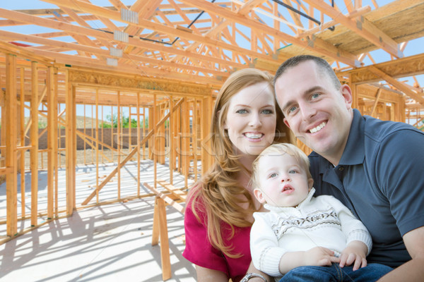 Young Military Family Inside The Framing of Their New Home at Co Stock photo © feverpitch