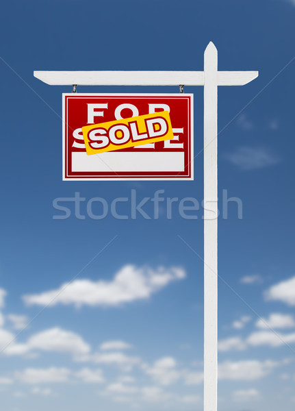 Left Facing Sold For Sale Real Estate Sign on a Blue Sky with Cl Stock photo © feverpitch