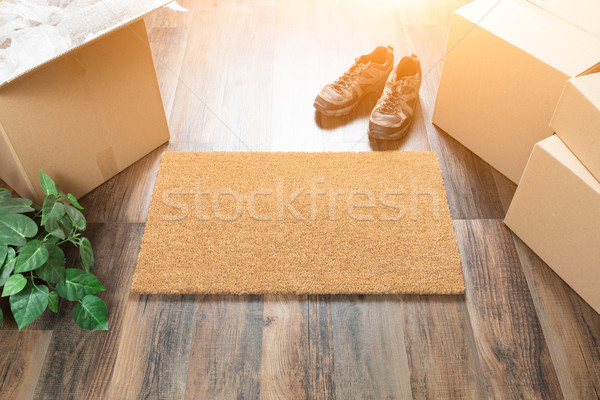 Blank Welcome Mat, Moving Boxes, Shoes and Plant on Hard Wood Fl Stock photo © feverpitch