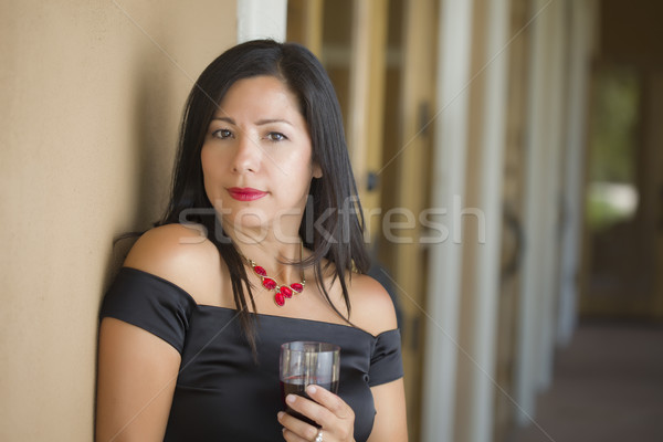 Attractive Hispanic Woman Portrait Outside Enjoying Wine Stock photo © feverpitch