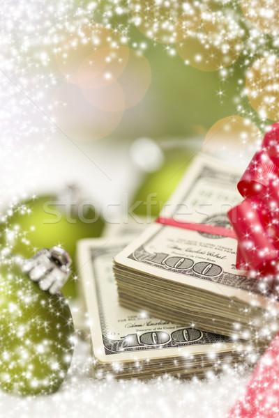 Stock photo: Stack of Hundred Dollar Bills with Bow Near Christmas Ornaments
