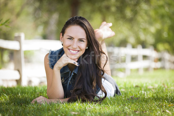 Attractive Mixed Race Girl Portrait Laying in Grass Stock photo © feverpitch