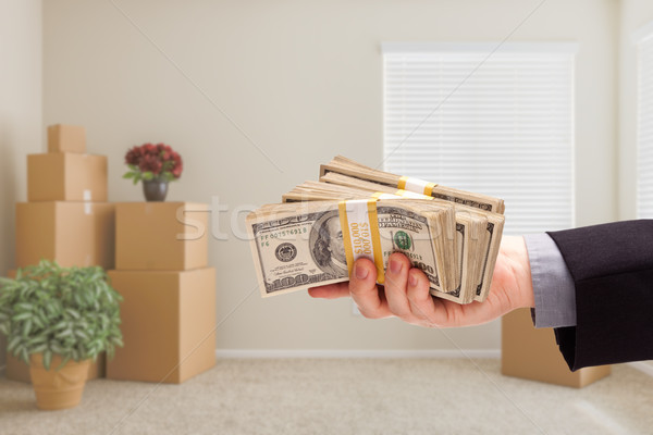 Handing Over Cash In Room with Packed Moving Boxes Stock photo © feverpitch