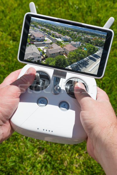 Hands Holding Drone Quadcopter Controller With Residential Homes Stock photo © feverpitch
