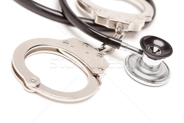 Stethoscope and Handcuffs on White Stock photo © feverpitch