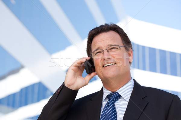 Businessman Smiles as He Talks on His Cell Phone Stock photo © feverpitch