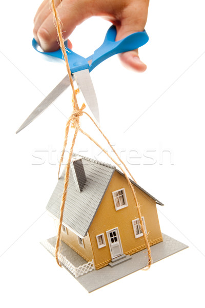 Hand with Scissors Cutting String Holding House Stock photo © feverpitch
