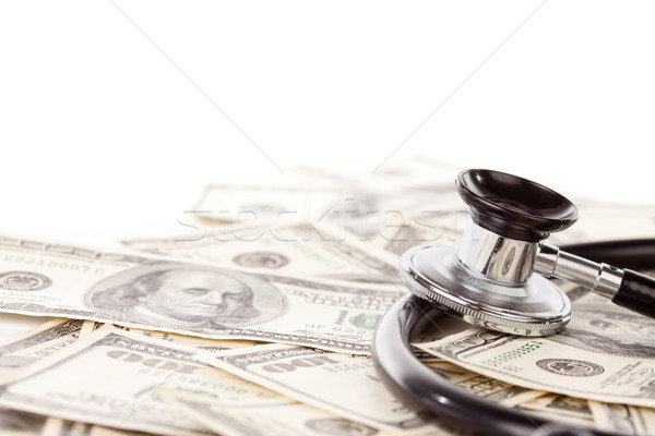 Stock photo: Stethoscope Laying on Stacks of Money