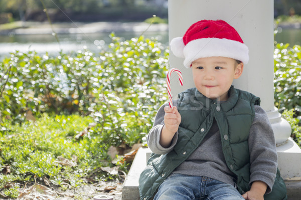 Cute Mixed Race Boy With Santa Hat and Candy Cane Stock photo © feverpitch