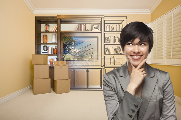 Mixed Race Female In Room With Drawing of Entertainment Unit Stock photo © feverpitch