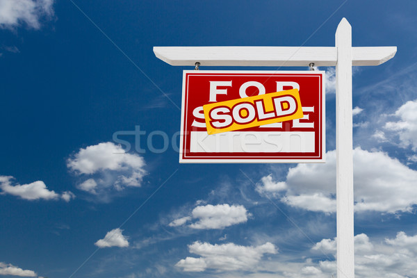 Left Facing Sold For Sale Real Estate Sign Over Blue Sky and Clo Stock photo © feverpitch