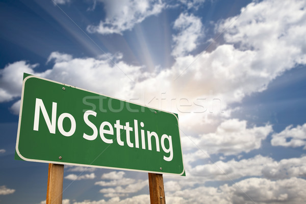 Stock photo: No Settling Green Road Sign and Clouds